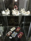 11 assorted Limoges minature tea sets (2 shelves).