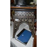 An inlaid table with tiled top.