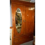 A mahogany inlaid wardrobe.