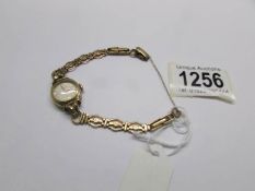 A Longine's 1950's gold plate wrist watch on a 9ct (375) gold bracelet.