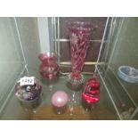 2 cranberry glass vases and 3 paperweights.