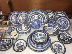 A Wedgwood meat plate & collection of blue & white Willow pattern dinner ware including gravy boats