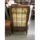 An astragal glazed bow fronted display cabinet