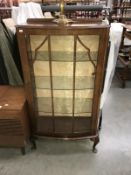 An astragal glazed bow fronted display cabinet