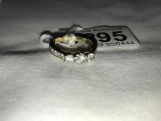 A 9ct gold ring set 3 diamonds and with diamond set shoulders, size M.
