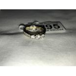 A 9ct gold ring set 3 diamonds and with diamond set shoulders, size M.