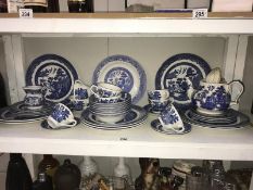 A quantity of Willow pattern blue & white dinner/tea ware