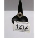 A 9ct gold ring set black stone and diamonds.