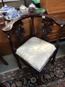 An ornately carved corner chair