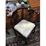 An ornately carved corner chair