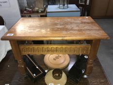 A carved wood coffee table on castors