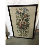 A framed and glazed embroidery flower pattern