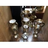 A quantity of brass vases