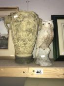 An oriental vase with elephant head and a concrete owl garden ornament