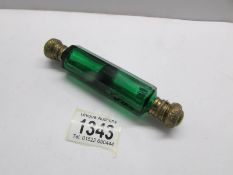 A Victorian green glass double ended scent bottle with gilt metal caps.