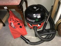 A Henry hoover with accessories bag