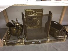 A collection of brass fireside items, fender, screens, buckets & companion set etc.