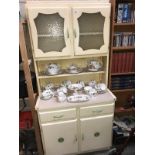A cream painted retro kitchen cabinet