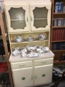 A cream painted retro kitchen cabinet