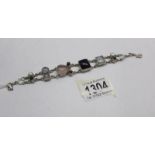 A multi gem bracelet set with pearls, garnet etc in silver.