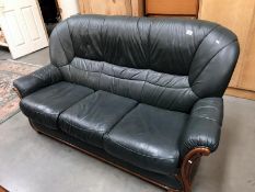 A wood framed green leather 3 seater sofa