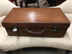 A large vintage leather suitcase.