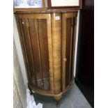 A bow fronted display cabinet