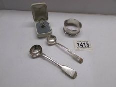 A silver napkin ring, 2 silver spoons and a silver ring.