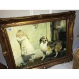 A gilt framed print of a girl with dog