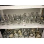 A shelf of drinking glasses,