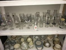 A shelf of drinking glasses,