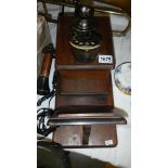 A vintage wall mounting telephone.