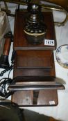 A vintage wall mounting telephone.