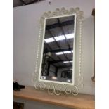 An ornate metal framed mirror