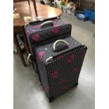 2 pink bow suitcases