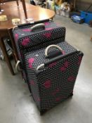 2 pink bow suitcases