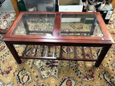 A wooden coffee table with glass inserts