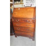 A slim mahogany bureau.