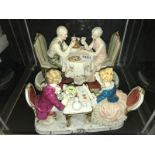 A Capo-di-Monte figure of an elderly couple drinking champagne entitled 'Anniversario' and a