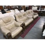 A wood framed tan leather living room suite consisting of 2 x 2 seater sofas & an armchair all with