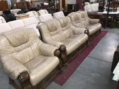 A wood framed tan leather living room suite consisting of 2 x 2 seater sofas & an armchair all with