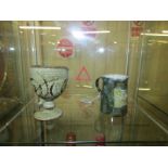 A Royal Doulton christening mug and an art pottery goblet.