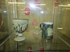 A Royal Doulton christening mug and an art pottery goblet.