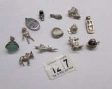 Approximately 14 charms and fobs including some silver.