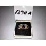 A 9ct gold ring set amethysts.