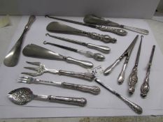 14 silver handled items including glove stretchers, button hooks, shoe horns, pickle fork etc.