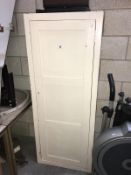 A painted white storage cupboard