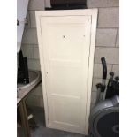 A painted white storage cupboard