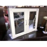 A mirrored bathroom wall cabinet