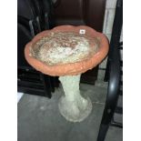 A concrete bird bath